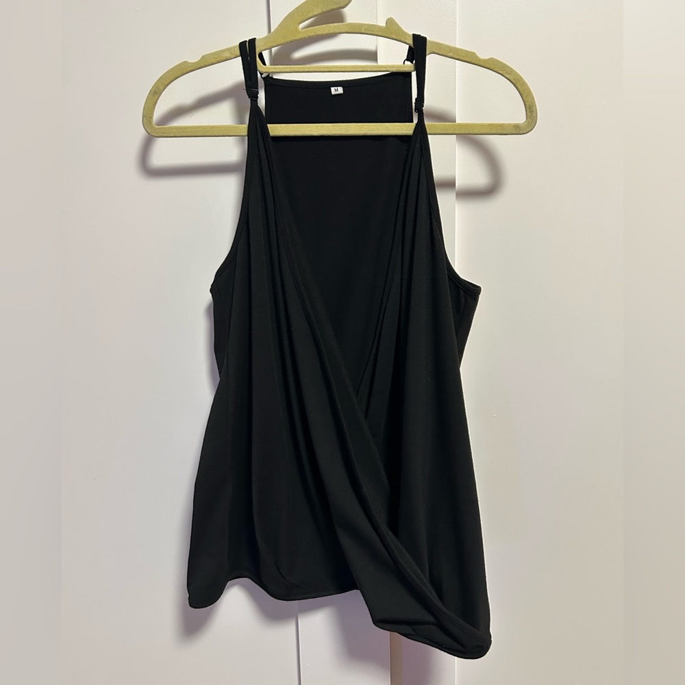 Black tank top with adjustable straps and a flattering fit. Size: M